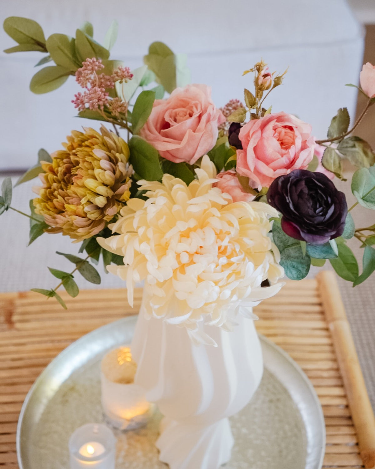 Close-up of cream, coral and burgundy flowers in the Amara silk bouquet