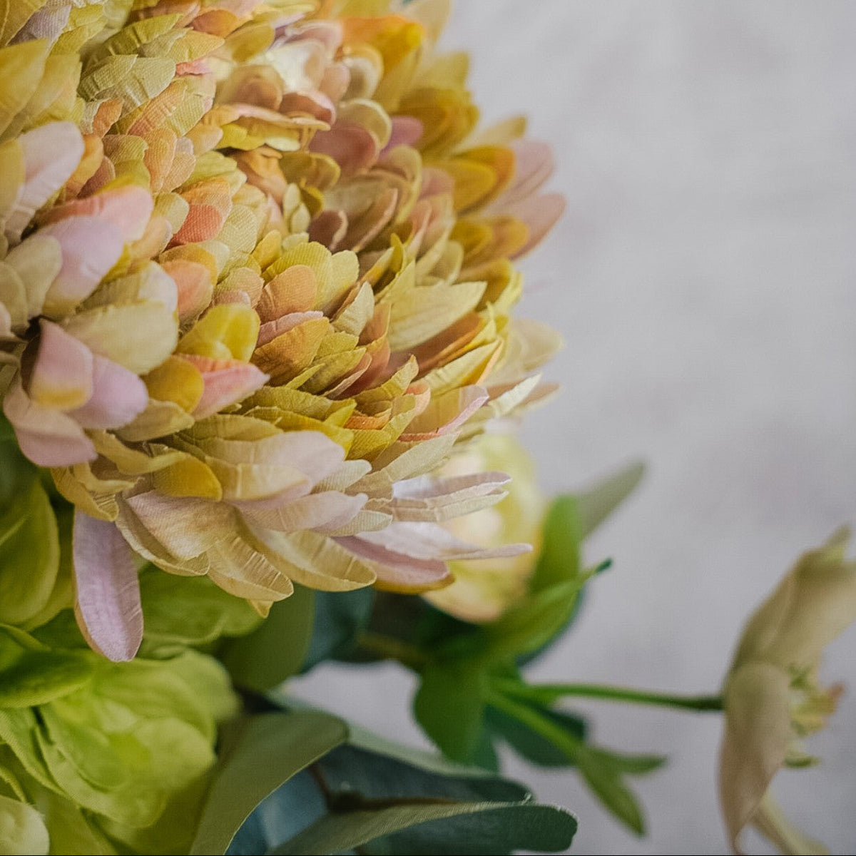 Close-up of a pink and green chrysanthemum in the Camille silk bouquet