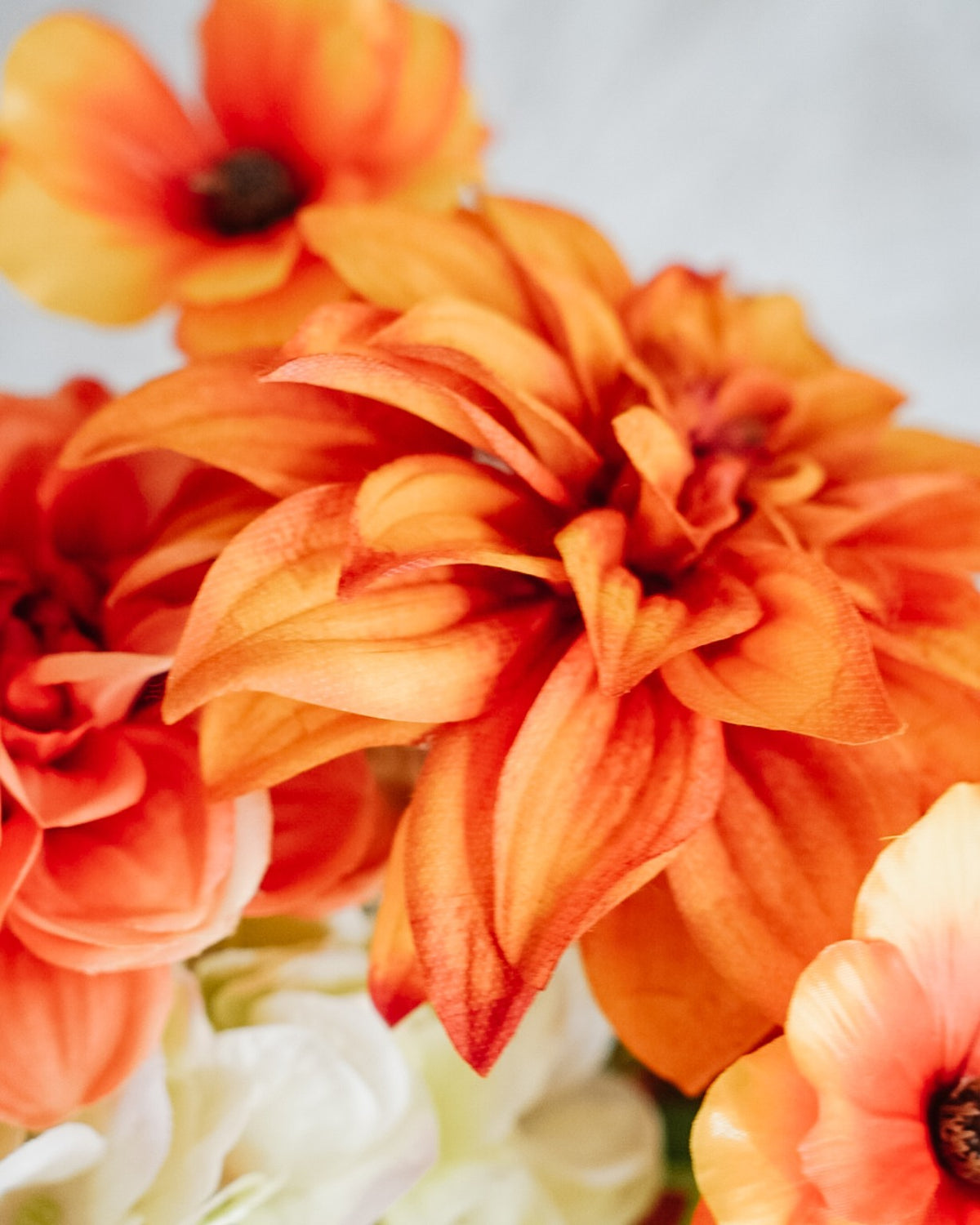 Close-up of an orange dahlia in the Capucine silk bouquet