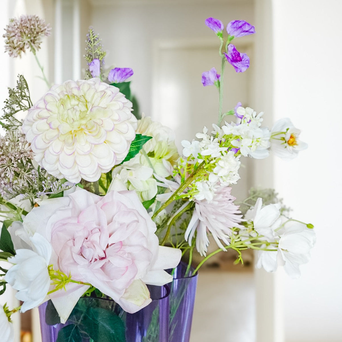 Pink, lilac and white flowers from the Isla bouquet in a vase
