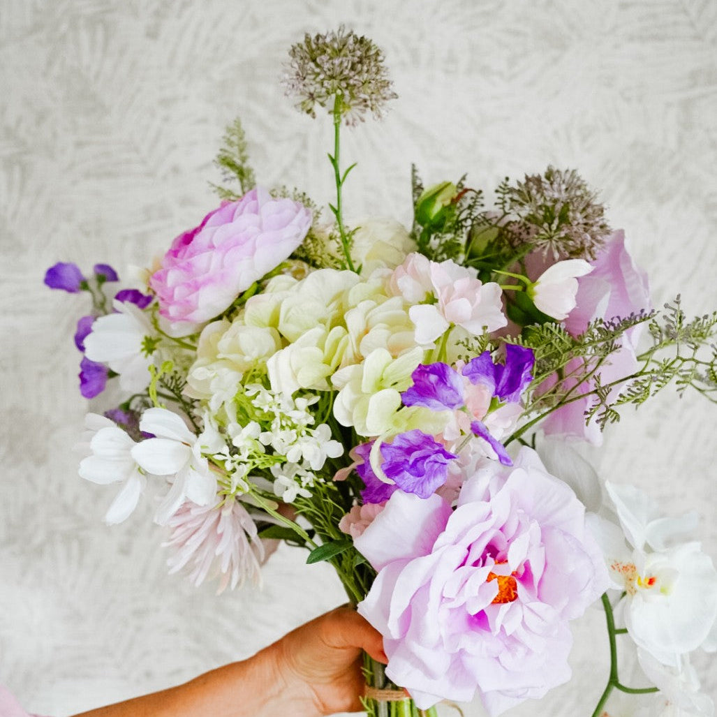 Close-up of white flowers and a pink bloom in the Isla bouquet