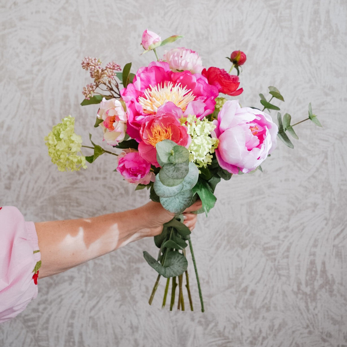 Violet silk flower bouquet in fuchsia, deep red and green tones