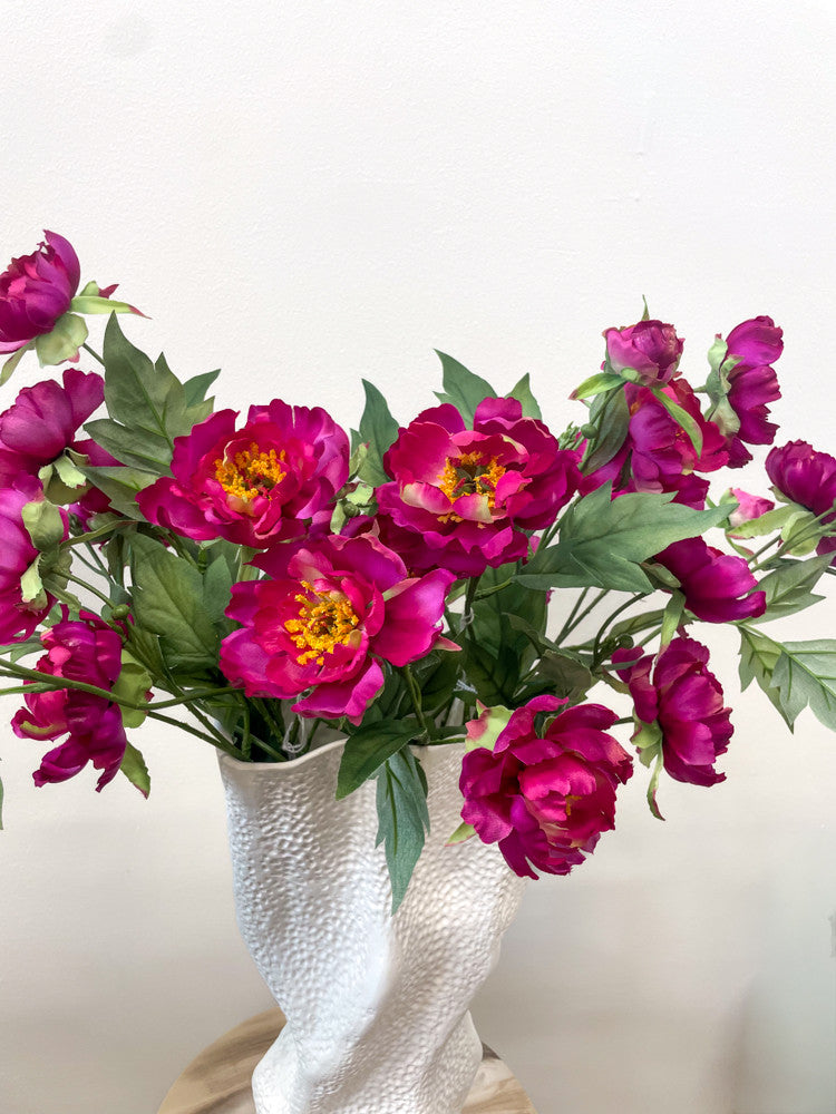 Fuchsia silk peony styled in an interior
