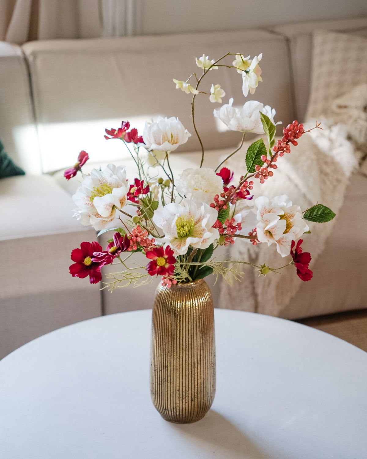 Saga silk flower bouquet in a gold vase in a living room