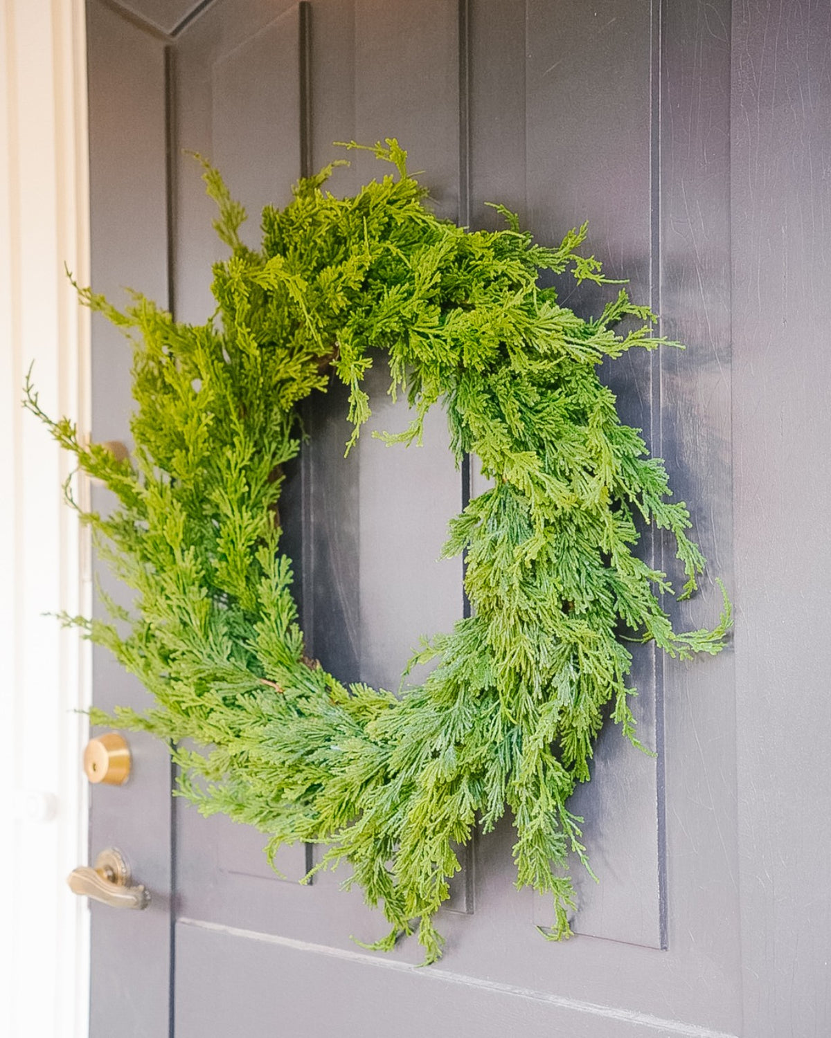 Large 55 cm silk evergreen wreath on a door, side view