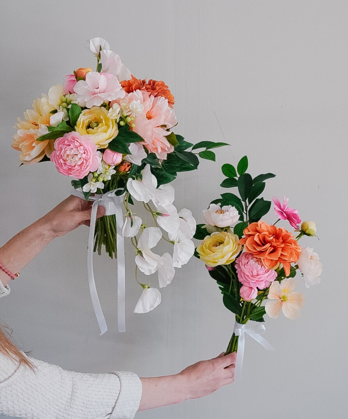 Two colourful silk wedding bouquets, one with cascading white blooms